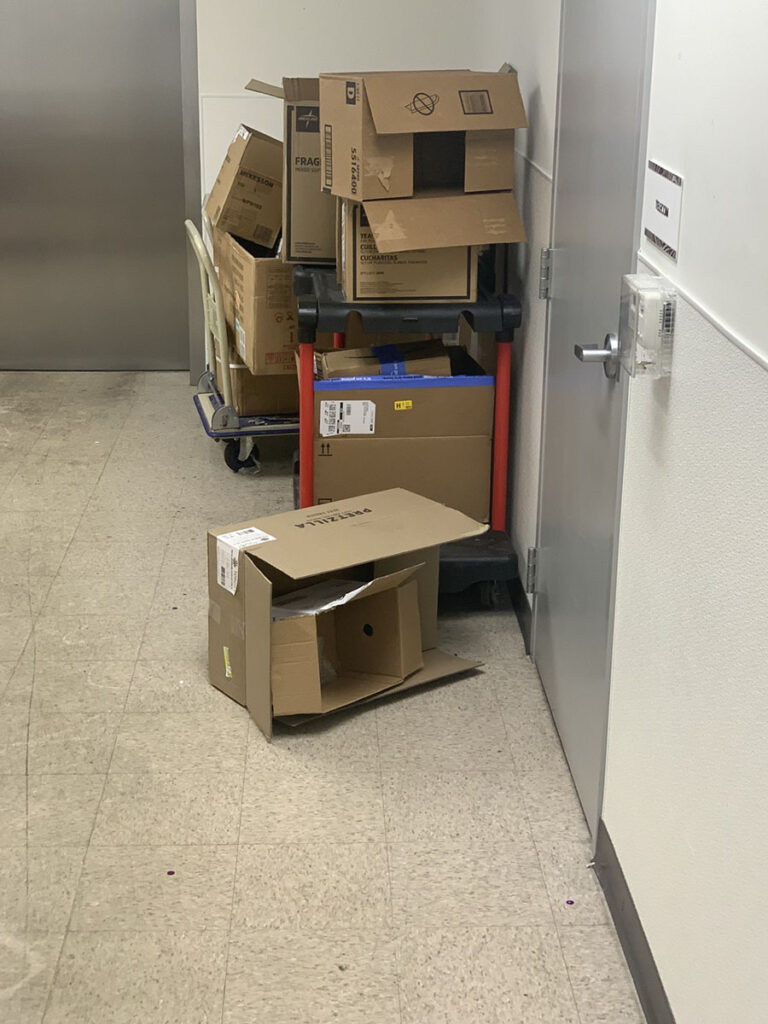 Boxes stacked in the corner of a room look cluttered, but they will be easily broken down during our spring cleaning process.